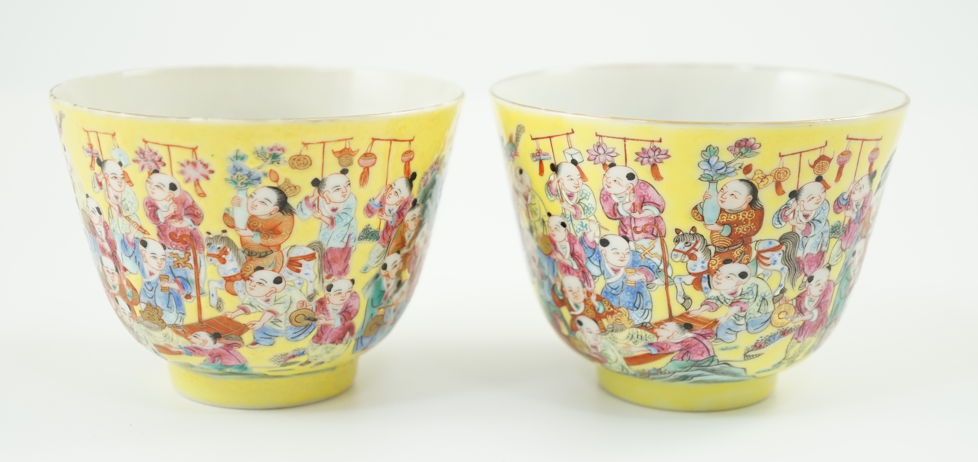 A pair of Chinese yellow ground 'Hundred Boys’ cups, 19th century, 6.5cm high 8.5cm diameter